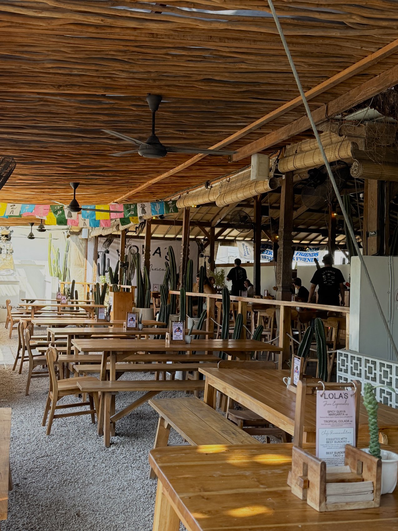 Lola's Uluwatu — open-air patio dining with cactus garden